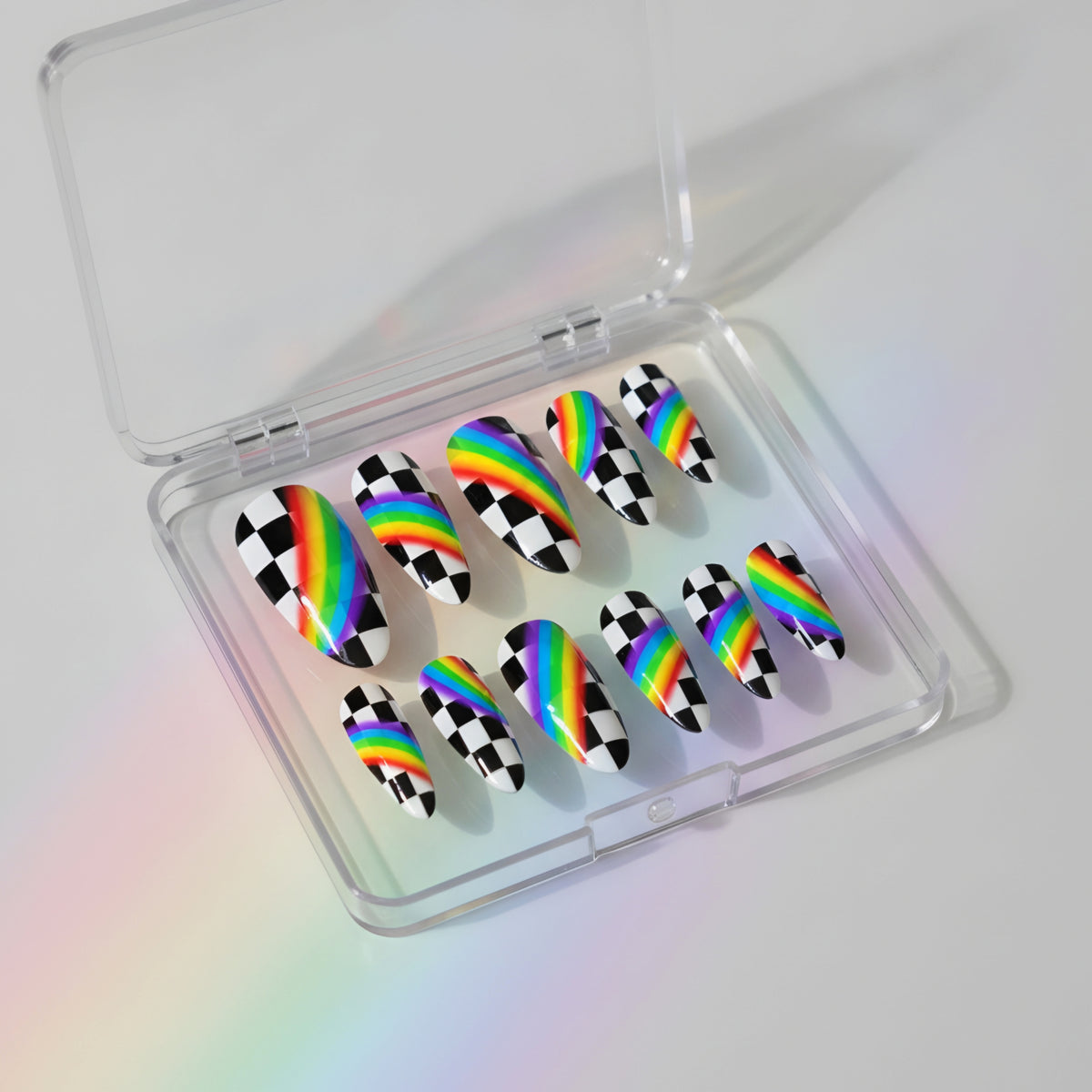 Rainbow Race rainbow press-on nails with black and white checkerboard nail art