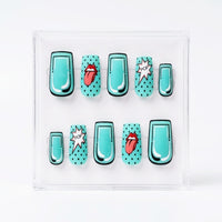 A set of 10 square press-on nails displayed in a clear plastic case against a white background. The nails feature a turquoise and black pop-art design with some decorated in black polka dots and others featuring red lips and white starburst speech bubbles.