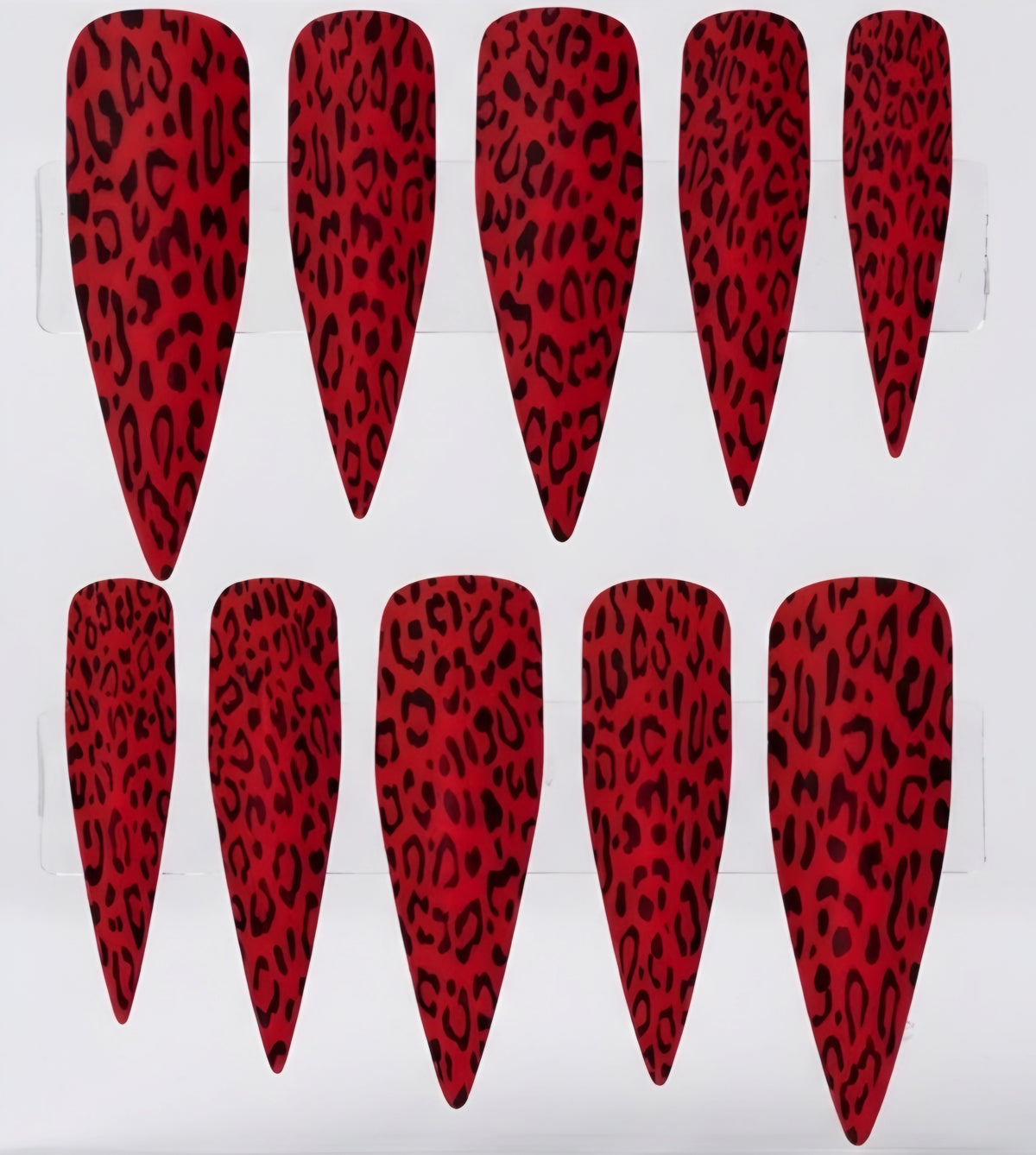 Ten matte red stiletto-shaped press-on nails with a black leopard print pattern, arranged in two rows on a white background.