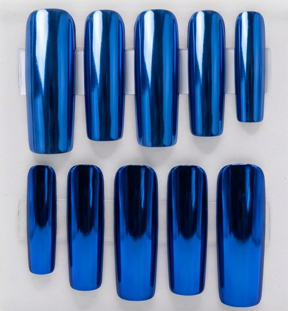 Ten glossy cobalt blue chrome nail tips arranged in two rows on a white background.