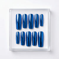 Ten glossy metallic blue chrome press-on nails arranged in two rows inside a clear plastic display case on a white background.