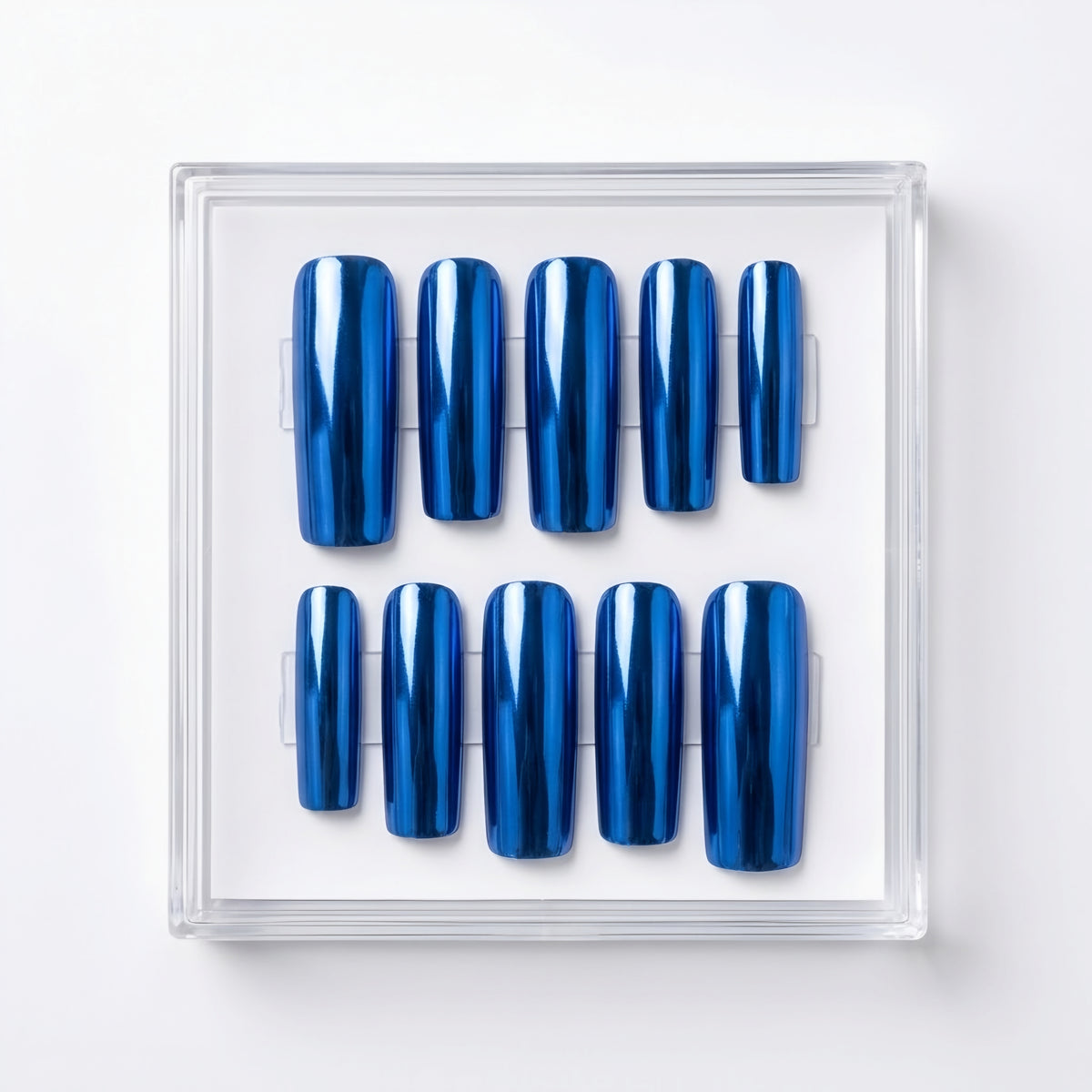 Ten glossy metallic blue chrome press-on nails arranged in two rows inside a clear plastic display case on a white background.