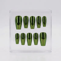 A set of ten metallic olive green chrome press-on nails arranged in two rows inside a clear plastic display box on a light gray background.