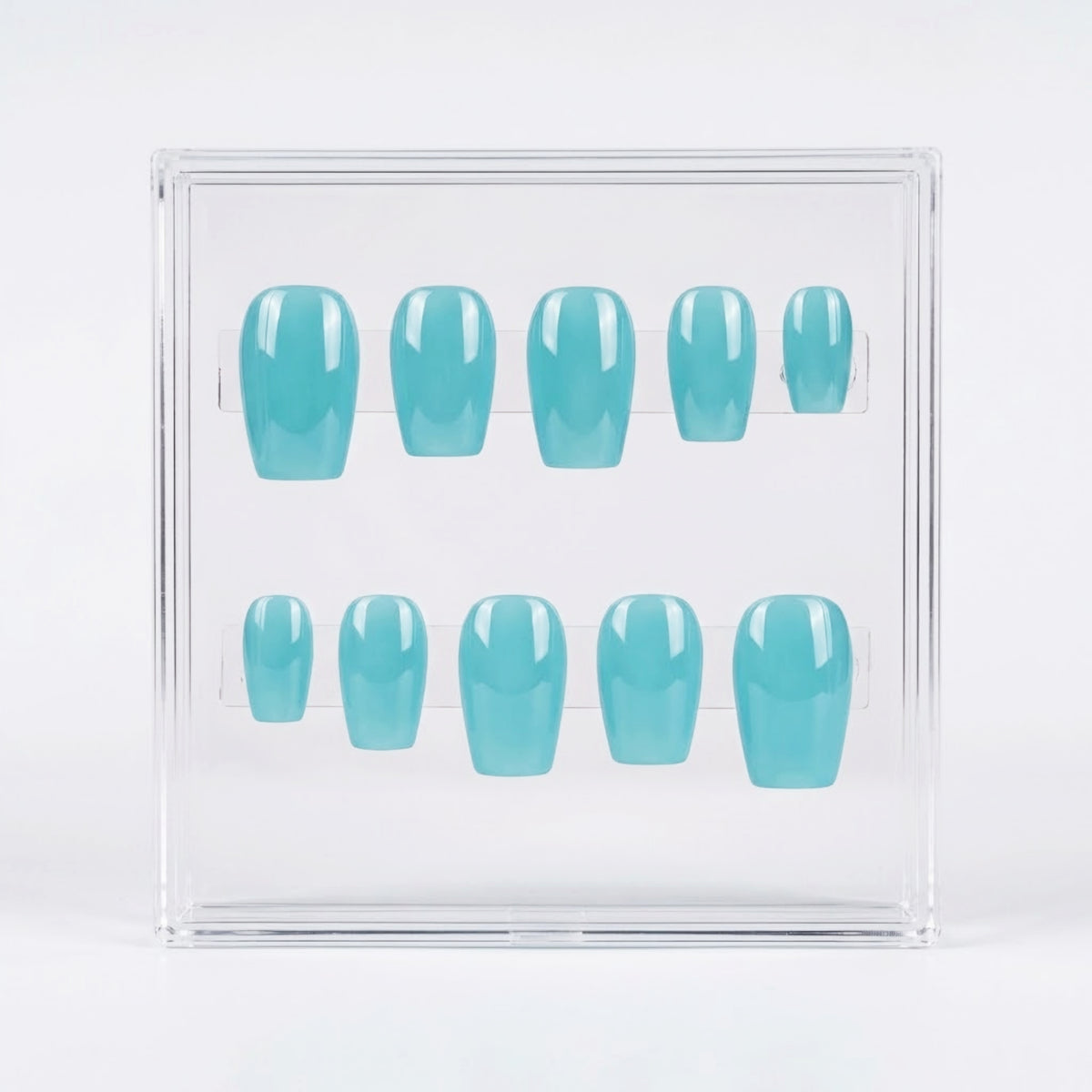A set of ten press-on nails in a glossy light aqua blue color, displayed inside a clear acrylic case on a white background.