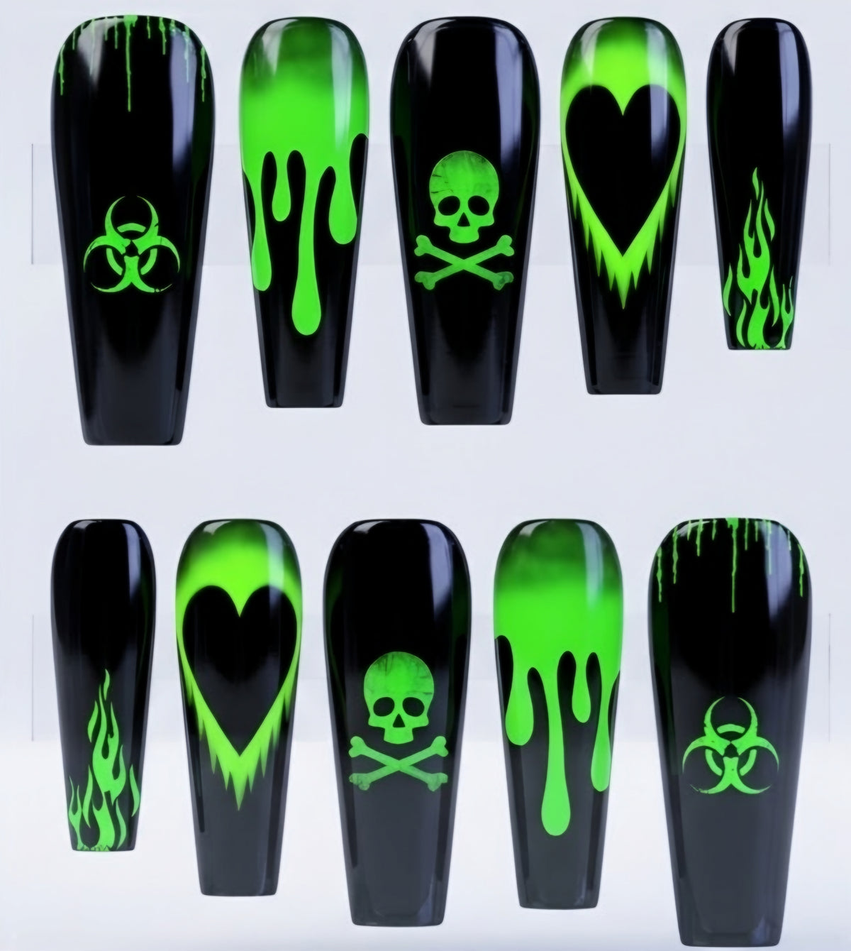 Ten coffin-shaped nail tips displayed in two rows, featuring black glossy backgrounds with neon green graphic designs including dripping paint, a heart, a skull and crossbones, flames, and a biohazard symbol.