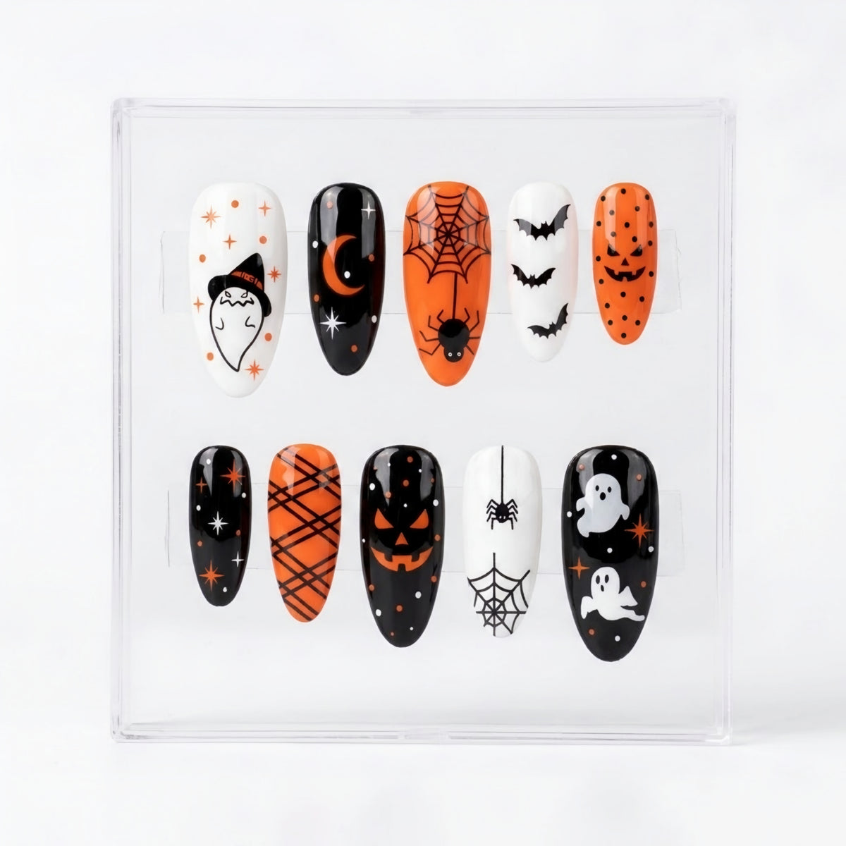 A set of 10 Halloween-themed press-on nails displayed in a clear plastic case against a white background. The nails feature various spooky designs including a witch's face, a crescent moon, a spiderweb, bats, jack-o'-lanterns, and ghosts in black, orange, and white colors.