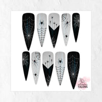 Web of Lies Halloween press-on nails with black spiderweb nail art, creepy spiders and white accents