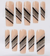 Ten press-on nails displayed on a clear plastic hanger against a white background. The nails have a nude beige base with diagonal stripes in black, metallic silver, and a leopard print pattern.
