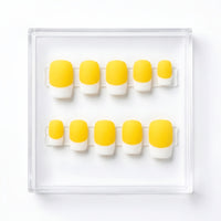 A set of ten press-on nails arranged in two rows inside a clear plastic display box on a white background. The nails feature a bright yellow base and a white french, creating a classic French manicure style.