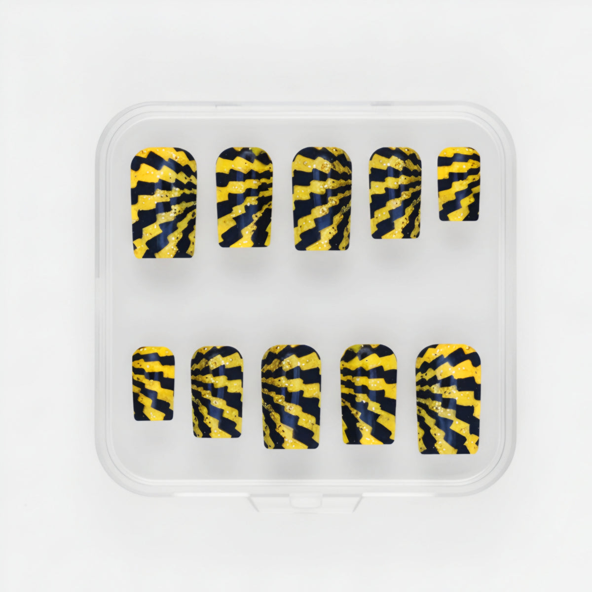 Radioactive yellow and black glow-in-the-dark press-on nails with gold glitter in short square
